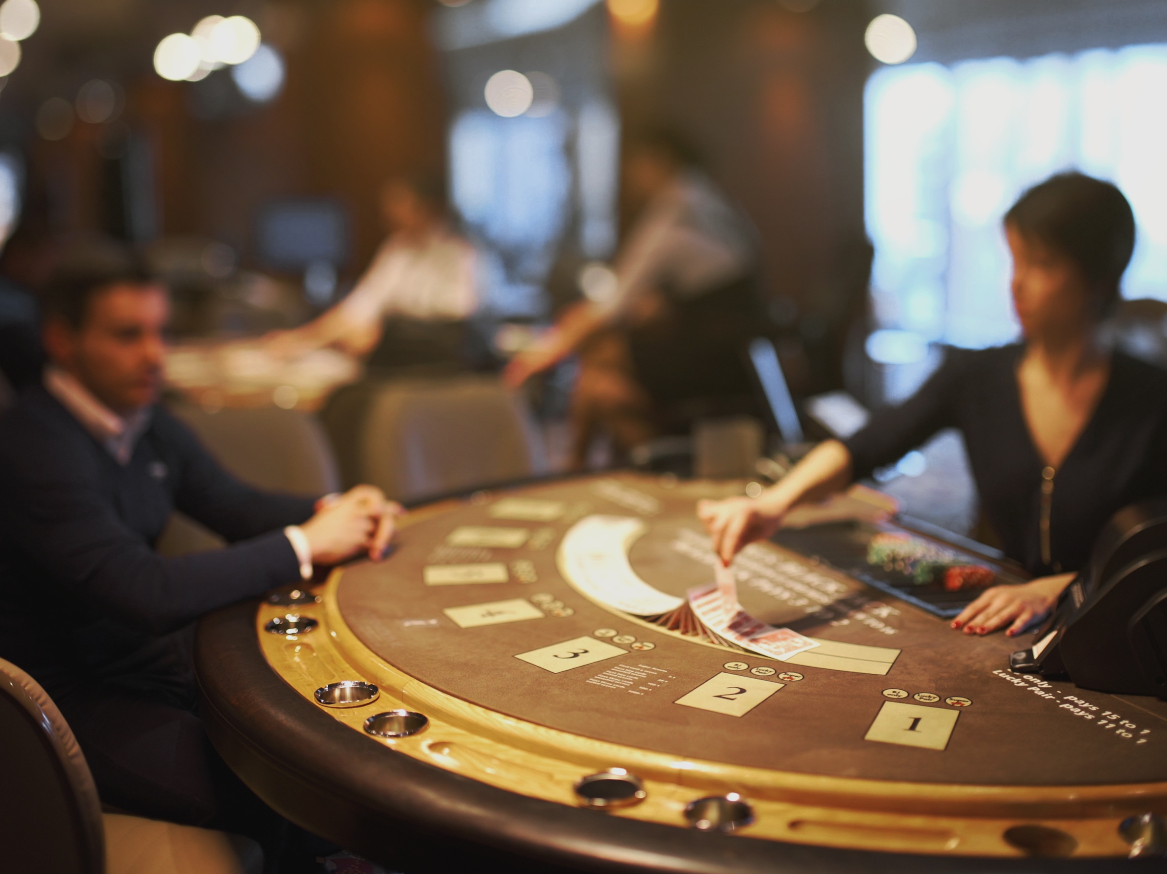 A Black Jack table at the casino with dealer and player